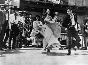 Elena Verdugo, Rian Valente (both dancing), on-set of the western film, "The Big Sombrero",