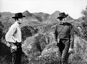 Barry Coe (left), Gregory Peck (right), on-set of the western film, "The Bravados", 20th