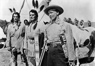 Keith Larson (left), Victor Mature (center), James Millican (right), on-set of the western film,