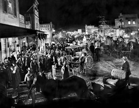 Crowd and street scene at night, on-set of the western film, "Cimarron", RKO Radio Pictures, 1931