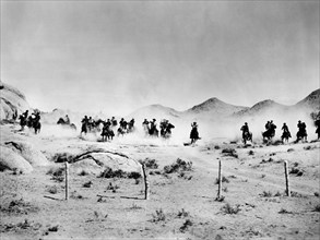 Cowpunchers on horseback, on-set of the western film, "Cow Town", Columbia Pictures, 1950