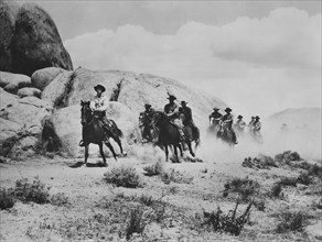 Cowpunchers on horseback, on-set of the western film, "Cow Town", Columbia Pictures, 1950