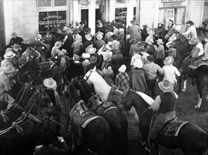 Crowd during run on the bank, on-set of the western film, "Dark Command", Republic Pictures, 1940