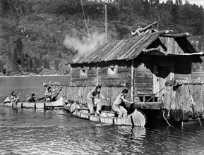 Huron warriors attacking log cabin, on-set of the western film, "The Deerslayer", 20th Century-Fox,