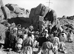 Group of Mission Indians in prayer, on-set of the western film, "Desert Pursuit", Monogram