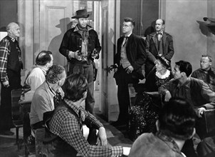 Wayne Morris (standing center holding two handguns), on-set of the western film, "The Desperado",