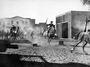 Bill Elliott (on horse, left), on-set of the western film, "Frontiers of '49", Columbia Pictures,