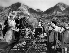 Yvonne De Carlo, Scott Brady (seated in buggy), on-set of the western film, "The Gal Who Won The