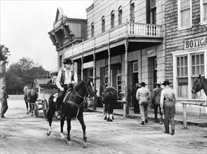 Rory Calhoun (on horse), on-set of the western film, "Domino Kid", Columbia Pictures, 1957