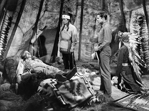 Morris Ankrum (on bed), Audie Murphy (standing right), on-set of the western film, "Drums Across