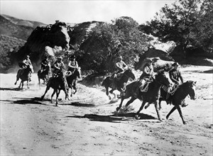 Gang of outlaws on horseback, on-set of the western film, "The Duel At Silver Creek", Universal