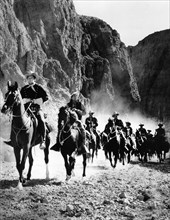 William Holden (foreground, left), on-set of the western film, "Escape From Fort Bravo", MGM, 1953