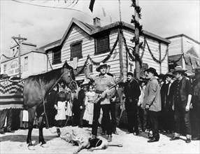 Stewart Granger (standing center with rifle), on-set of the western film, "Flaming Frontier",