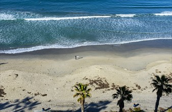 High angle view of surfers at ocean beach