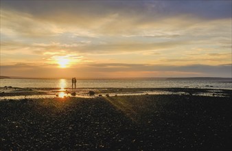 Couple on beach at sunset