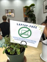 Laptop-Free Zone sign on café window