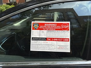 Wheel clamp device warning sign on car window