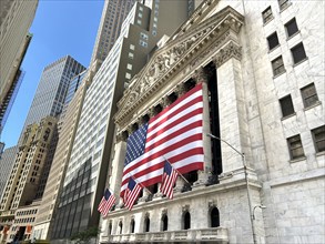 New York Stock Exchange, building exterior draped with large American flag, New York City, New