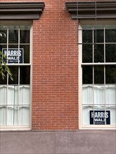 Two Harris Walz political campaign signs in residential window, Greenwich Village, New York City,