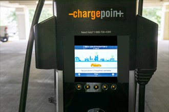 Close-up of electric vehicle charging station touch screen, IKEA home furnishings store parking