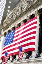 New York Stock Exchange, building exterior draped with large American flag, New York City, New