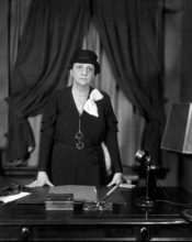 Frances Perkins, U.S. Secretary of Labor 1933-45, half-length portrait standing at her desk,