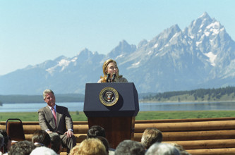 U.S. First Lady Hillary Rodham Clinton delivering remarks, as U.S. President Bill Clinton looks on,