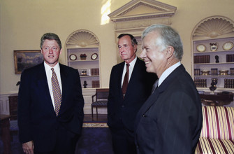 U.S. President Bill Clinton talking with former U.S. Presidents George H.W. Bush and Jimmy Carter,