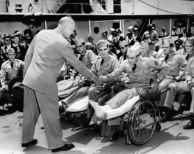 U.S. President Dwight D. Eisenhower greeting hospitalized veterans at Washington Navy Yard who were