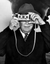 U.S. President Dwight D. Eisenhower photographing his photographers at the airport prior to his