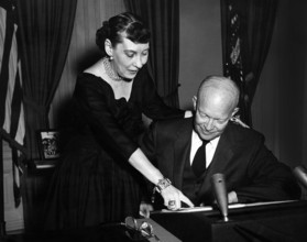 U.S. President Dwight D. Eisenhower and U.S. First Lady Mamie Eisenhower talk prior to the