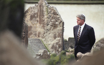 U.S. President Bill Clinton walking among graves during visit to historic Jewish cemetery, Prague,