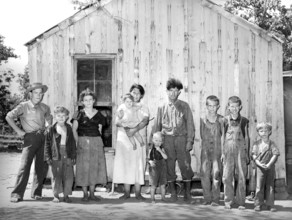 Family of agricultural day laborer standing in front of their two-room shack, McIntosh County,