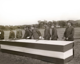 Japanese surrender party placing swords on table in final act of surrender in the presence (not