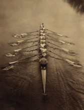 Eight rowers and coxswain rowing in sculling boat on river, Cambridge, England, UK, Bain News