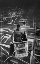 Close-up view of American major in observation balloon basket flying over territory near front