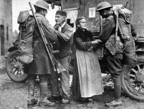 French couple, M. and Mme. Baloux, under German occupation for over four years, greeting U.S.