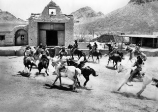 Apache fighters on horseback attacking a mission, on-set of the western film, "The Guns Of Fort