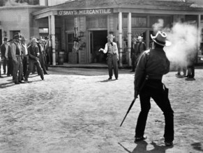 Paul Kelly (gun duel front view), Audie Murphy (gun duel rear view) , on-set of the western film,