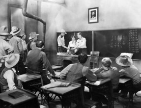 Lina Basquette (at desk, center), Hoot Gibson (at desk, right), on-set of the western film, "The