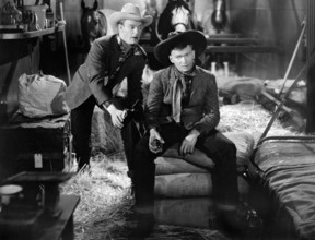 Dennis O'Keefe, Buddy Ebsen, on-set of the western film, "The Kid From Texas", MGM, 1939