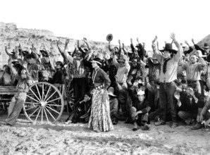 Dorothy Appleby (standing center), on-set of the western film, "King Of The Wild Horses", Columbia