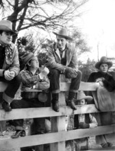 Robert Montgomery (center, sitting on fence), on-set of the western film, "Lovers Courageous", MGM,