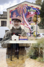 Reflection of mature adult man taking a selfie in store window