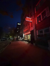 Liquor store and street scene at night, Chelsea, New York City, New York, USA