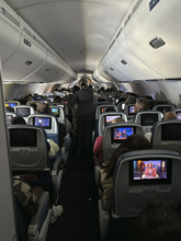 Rear view of passengers aboard commercial airplane