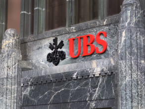 UBS Group AB, office building exterior with company logo and sign above entrance, New York City,