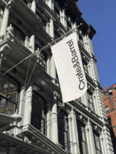 Crate & Barrel store banner hanging from exterior store building, low angle view, New York City,