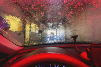 View from car interior of car being washed at car wash