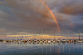 Rainbow and dramatic sky over harbor, Traverse City, Michigan, USA